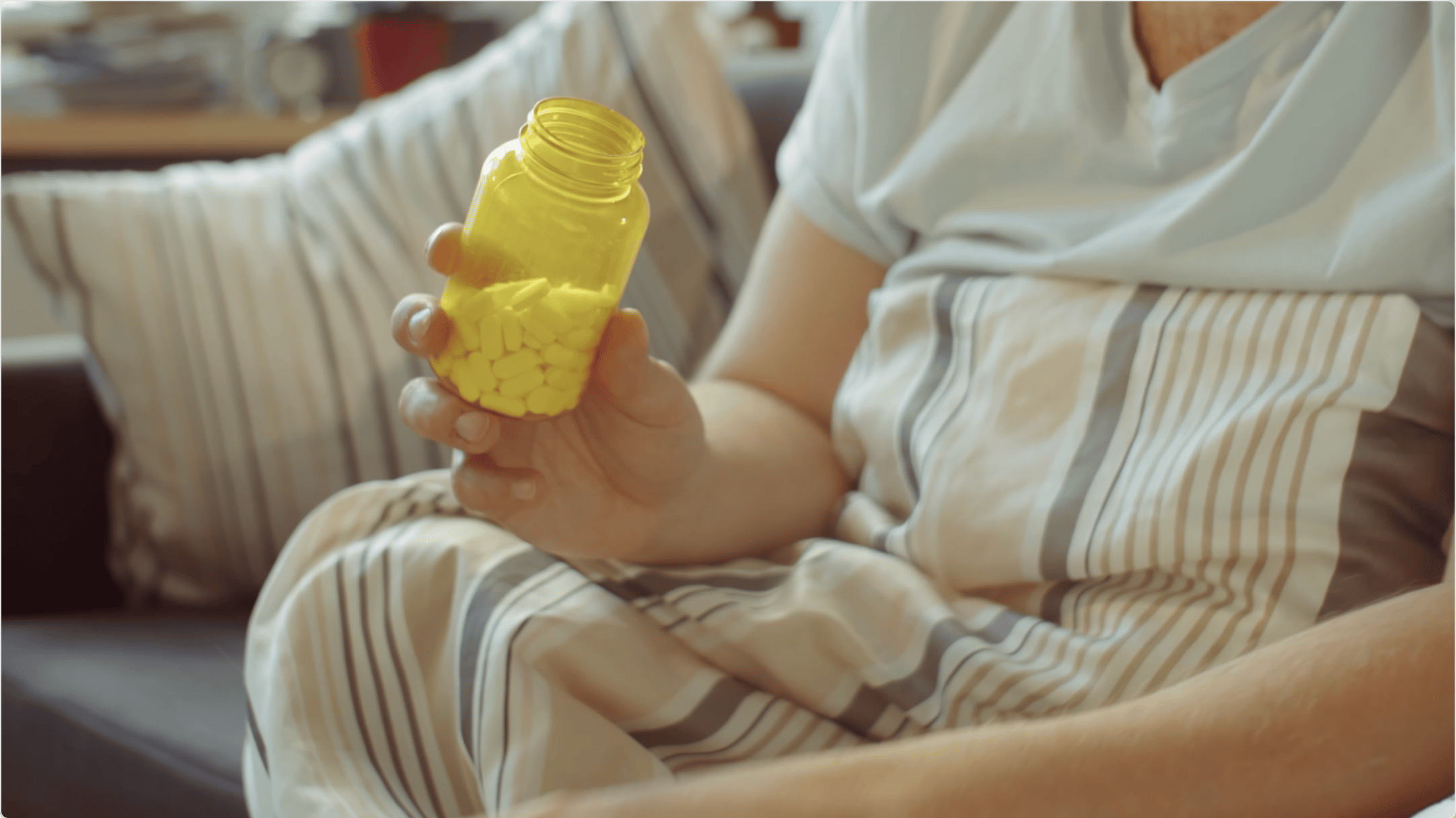 woman holding a bottle of pills