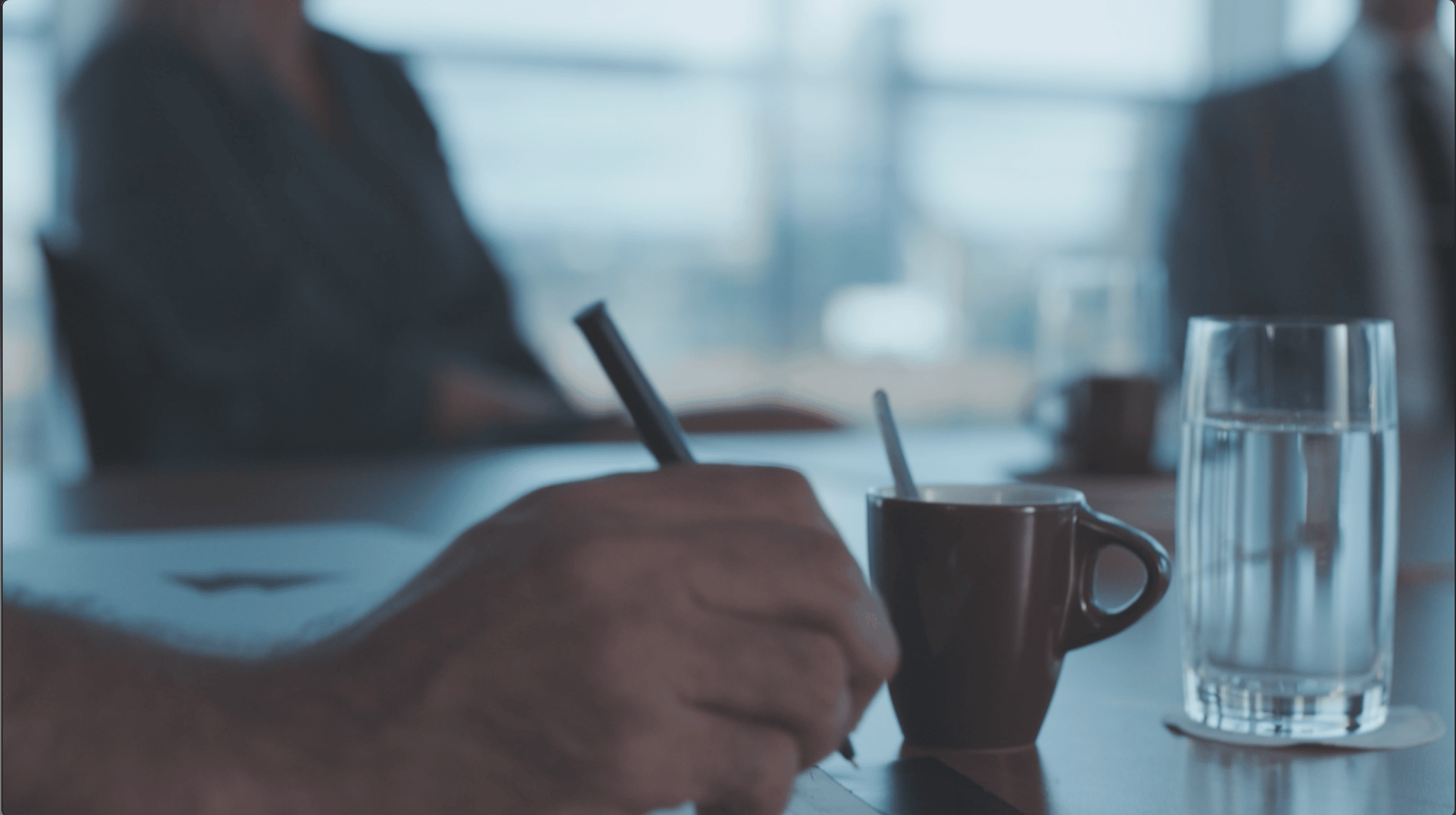 man holding a pen at a meeting