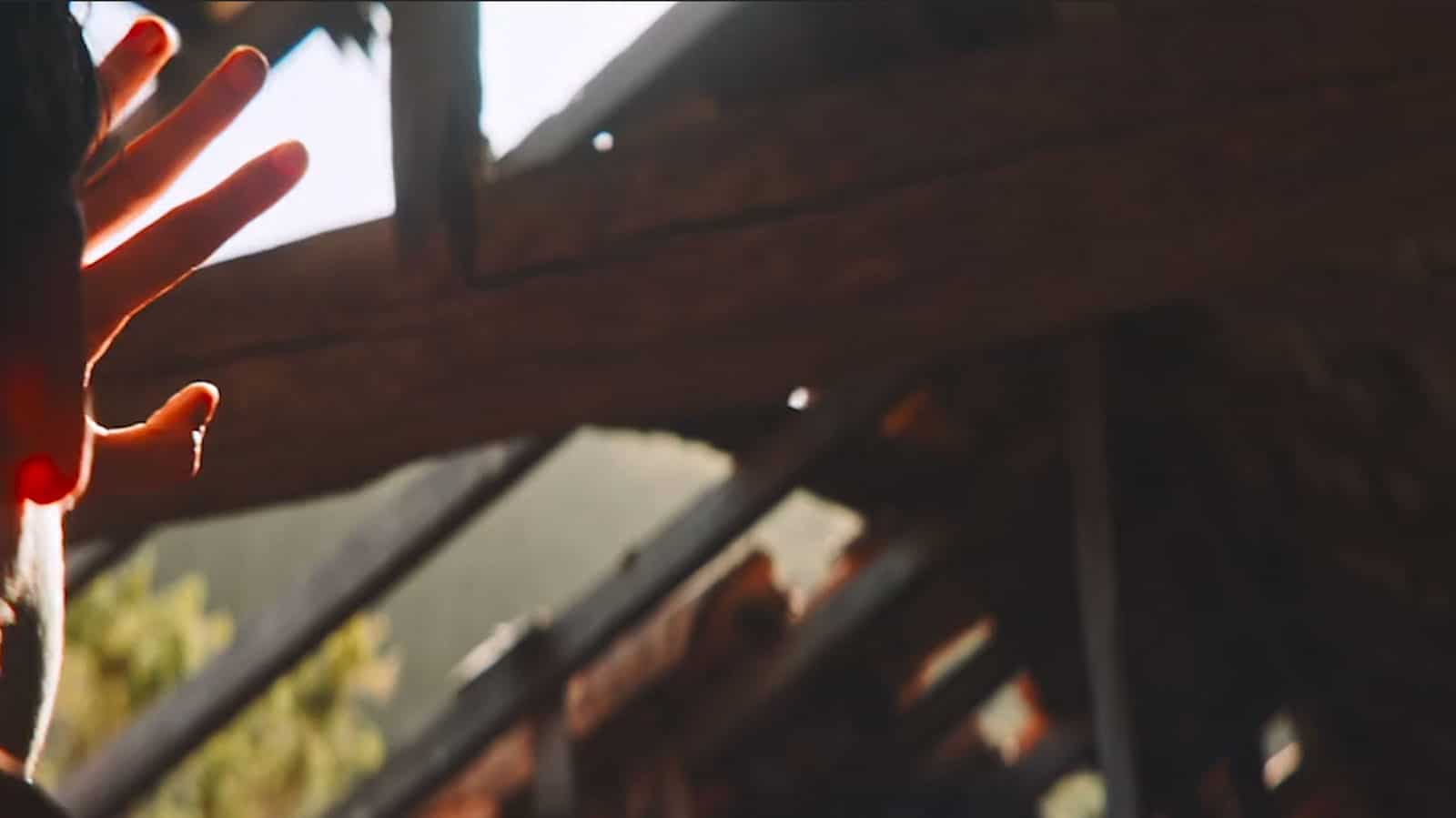 Homeowner looking up to a hole in the roof