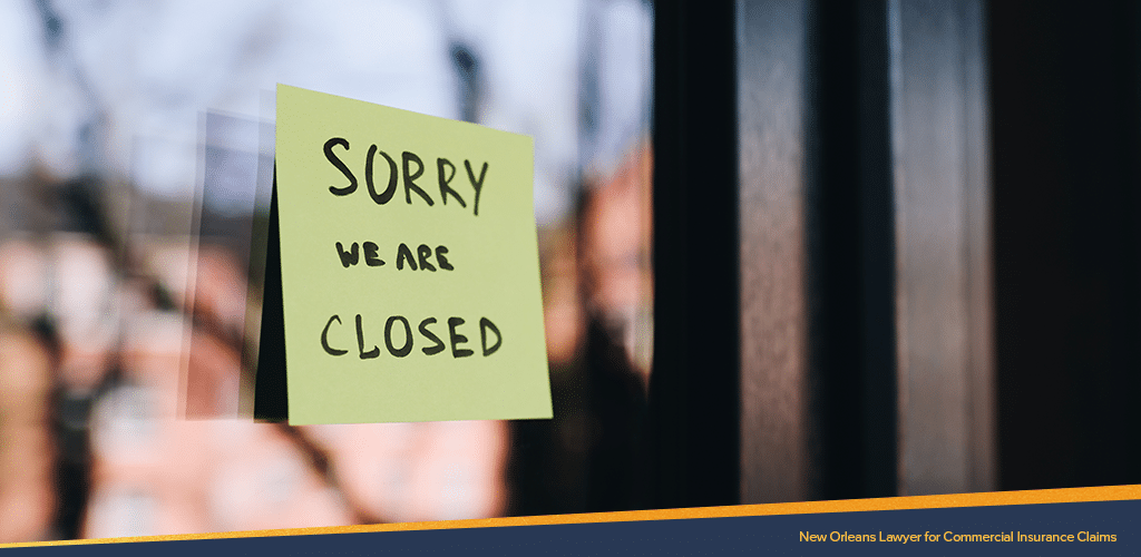 A sticky paper saying "SORRY WE ARE CLOSED" pasted on a glass door