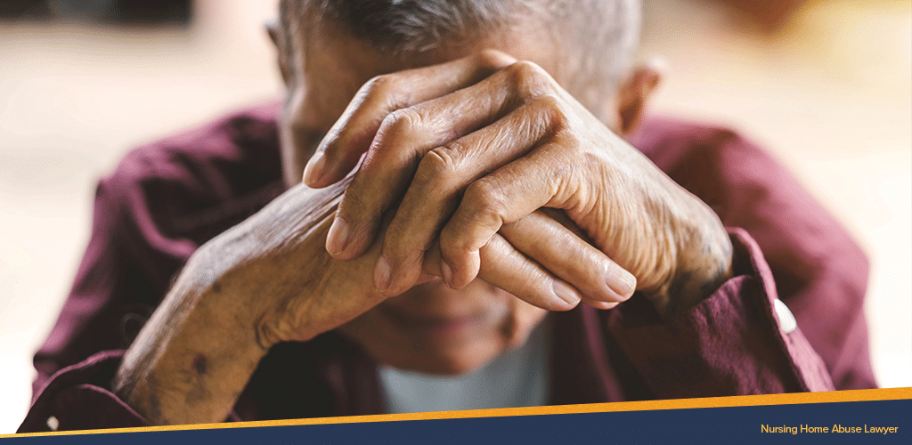 Depressed old man doing a sad pose and seemingly abused in a nursing home