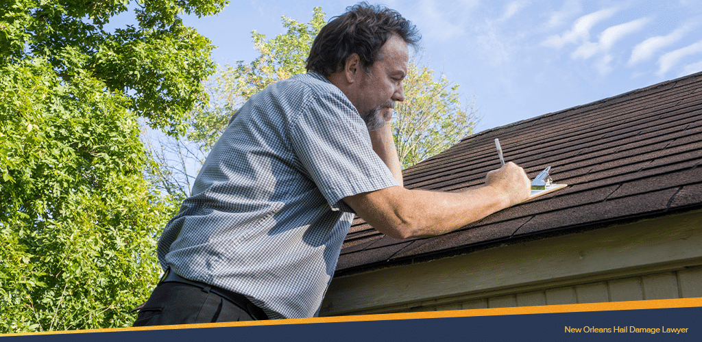man writing down details using the roof as a table