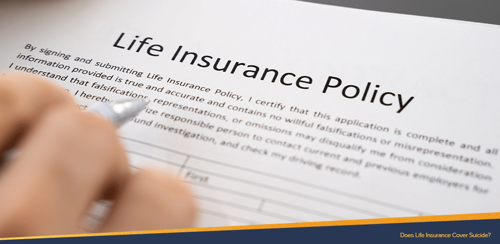 Life insurance policy for suicide being read by someone holding a pen