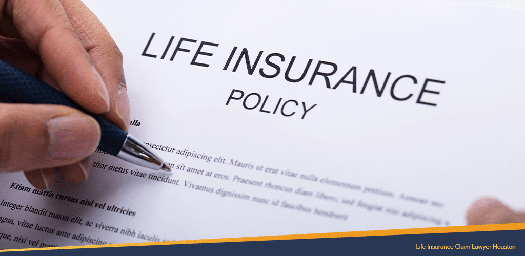 a close up life insurance policy claim paper being read by someone holding a pen