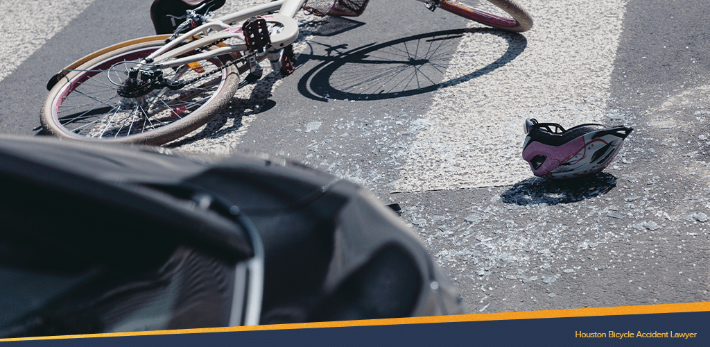 Bicycle accident in houston with a helmet and broken glasses scattered on the pedestrian lane
