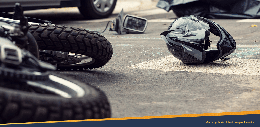 broken helmet and accessories scattered on the road from a motorcycle accident