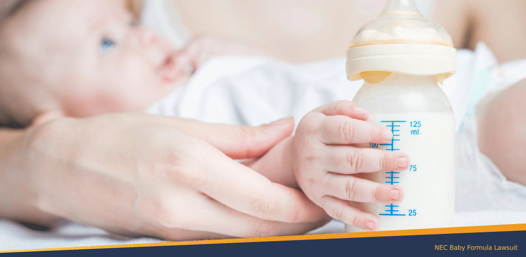 A mother guiding her baby's hand holding a milk bottle
