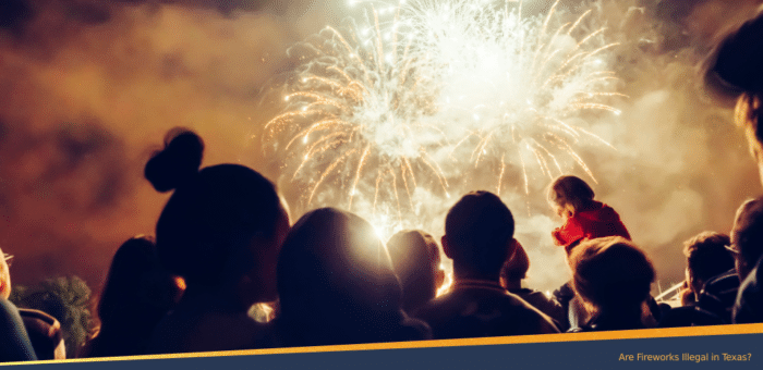Crowd of people watching a fireworks display at night, with bright explosions lighting up the sky, illustrating the topic of fireworks legality in Texas.