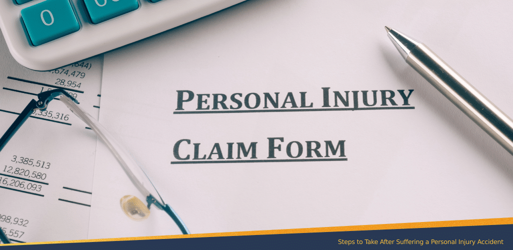 Close-up of a personal injury claim form with a pen, eyeglasses, and calculator, representing the process of filing a claim after an accident.